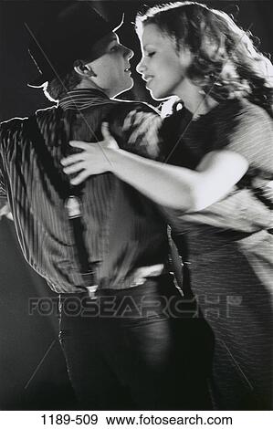Stock Photo - people, hat, couple, dancing, swinging, swing, motion. Fotosearch