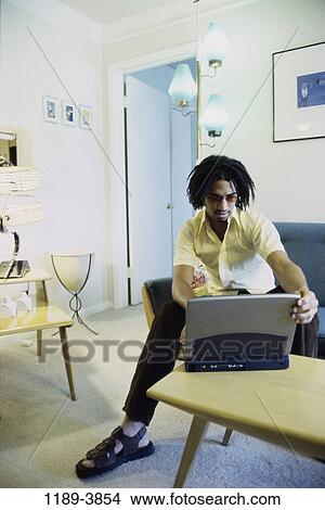 Picture - people, home, computer, laptop, indoors. Fotosearch