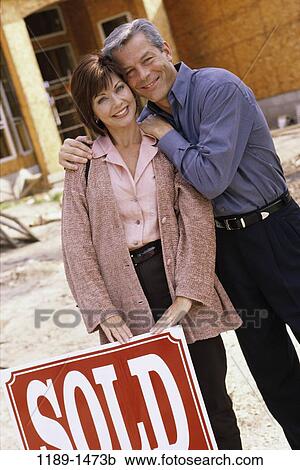Stock Image - people, home, new, outdoors, Middle-aged, new home, Middle-aged outdoors new home. Fotosearch