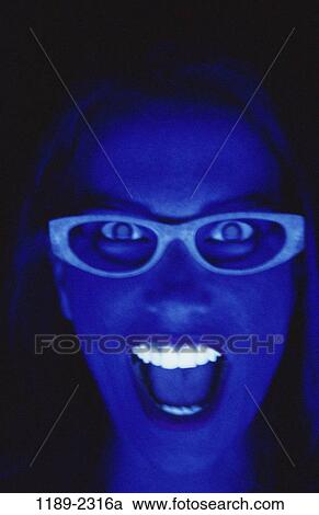 Stock Image - people, light, woman, black, anger, eyeglasses, teeth. Fotosearch