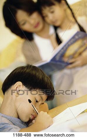 Stock Photo - people, pen, home, Asian, reading, homework, book. Fotosearch