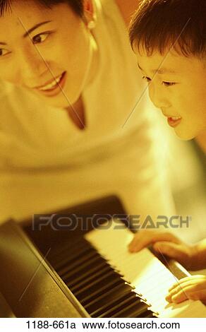 Stock Image - people, playing, Asian, mother, music, piano, family. Fotosearch