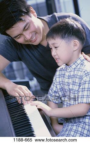 Stock Photography - people, playing, Asian, reading, music, family. Fotosearch