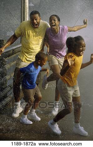 people, rain, splash, outdoors, weather, family, surprise View Large Photo Image Stock Image - people, rain, splash, outdoors, weather, family, surprise. Fotosearch