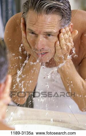 Stock Image - people, reflection, water, face, splash, cleaning. Fotosearch