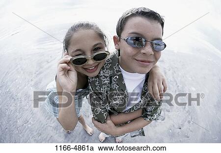 Stock Image - people, reflection, water, smiling, beach, sunglasses. Fotosearch