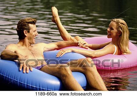 people, relaxation, floating, couple, laughing, Middle-aged, relaxing View Large Photo Image Stock Image - people, relaxation, floating, couple, laughing, Middle-aged, relaxing. Fotosearch
