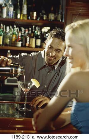 Stock Image - people, relaxation, pouring, drinking, bar, relaxing, alcoholic. Fotosearch