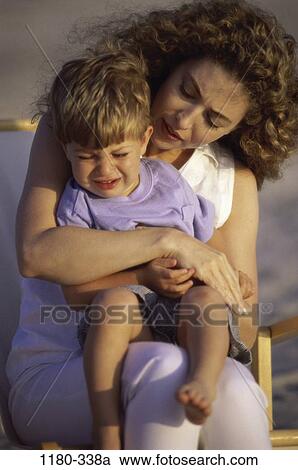 Stock Image - people, sitting, mother, calm, holding, outdoors, family. Fotosearch