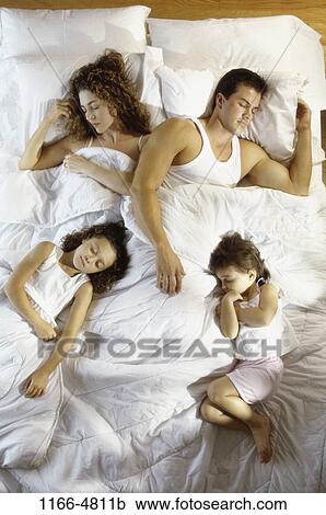 Stock Image - people, sleeping, Hispanic, bed, family, daughters, asleep. Fotosearch