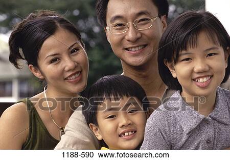 Stock Image - people, smiling, Asian, eyeglasses, outdoors, family. Fotosearch