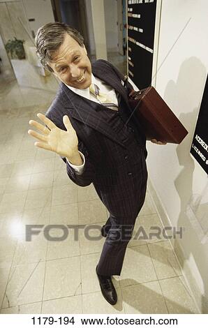 people, smiling, briefcase, gesturing, business, Middle-aged View Large Photo Image Picture - people, smiling, briefcase, gesturing, business, Middle-aged. Fotosearch