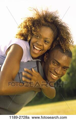 Stock Image - people, smiling, couple, happy, laughing, playful, outdoors. Fotosearch