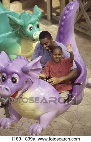 Stock Image - people, smiling, excitement, riding, outdoors, amusement, entertainment. Fotosearch
