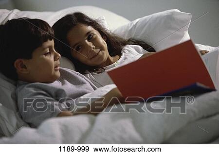 people, smiling, Hispanic, reading, bed, book View Large Photo Image Stock Photo - people, smiling, Hispanic, reading, bed, book. Fotosearch