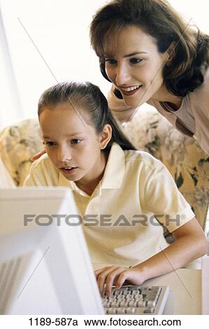 Stock Image - people, smiling, mother, computer, looking, watching, smile. Fotosearch