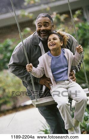 people, smiling, playing, laughing, swinging, swing, playful View Large Photo Image Stock Image - people, smiling, playing, laughing, swinging, swing, playful. Fotosearch