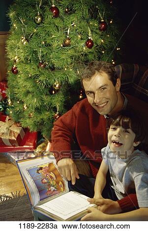 Stock Image - people, smiling, reading, Christmas, laughing, book, smile. Fotosearch