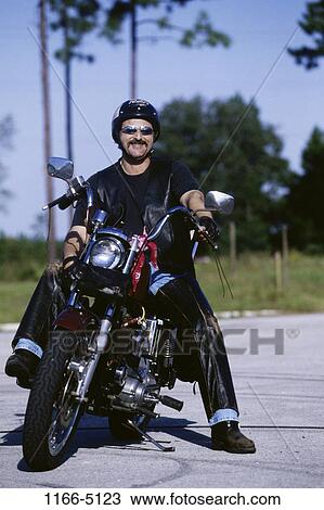 Stock Image - people, smiling, sitting, helmet, driving, motorcycle. Fotosearch