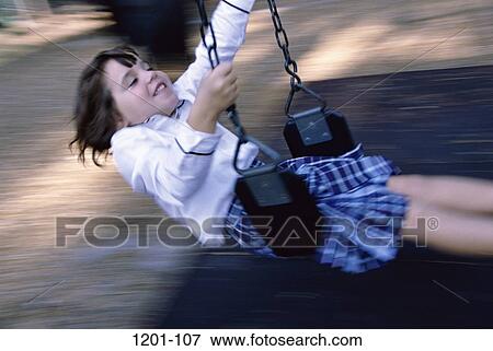 Stock Photo - people, swinging, girl, swing, playground, speed, child. Fotosearch