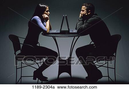 people, table, staring, couple, Hispanic, chairs, computers View Large Photo Image Stock Image - people, table, staring, couple, Hispanic, chairs, computers. Fotosearch