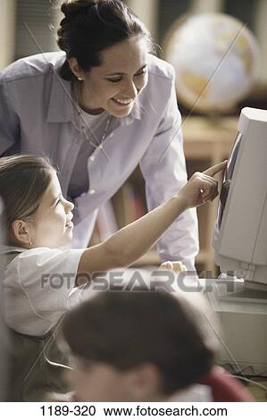 Stock Image - people, teacher, school, computer, classroom, pointing, point. Fotosearch