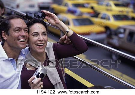 Stock Image - people, urban, couple, city, riding, street. Fotosearch