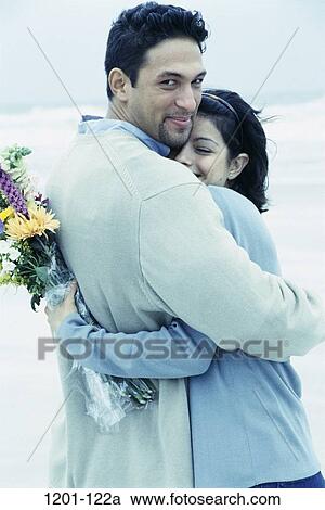 people, water, couple, Hispanic, beach, flowers, hugging View Large Photo Image Stock Image - people, water, couple, Hispanic, beach, flowers, hugging. Fotosearch