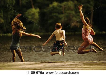 Stock Image - people, water, jump, playing, jumping, lake, playful. Fotosearch