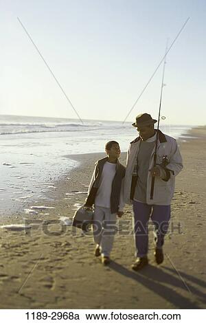 Stock Image - people, water, morning, hat, walking, talking, conversation. Fotosearch