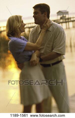 people, water, smiling, couple, holding, outdoors, Middle-aged View Large Photo Image Stock Image - people, water, smiling, couple, holding, outdoors, Middle-aged. Fotosearch