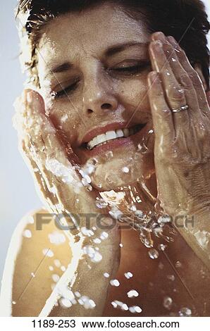 Stock Image - people, water, woman, face, splash, cleaning, Middle-aged. Fotosearch