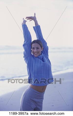 people, water, woman, smiling, beach, sweater, stretching View Large Photo Image Stock Image - people, water, woman, smiling, beach, sweater, stretching. Fotosearch