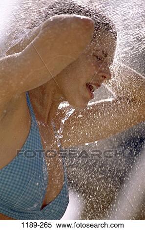 Stock Photography - people, water, woman, spraying, outdoors, cool, wet. Fotosearch