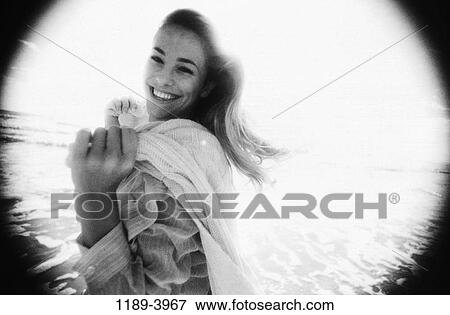 Stock Photo - people, woman, beach, black and white, clothed, monochromatic. Fotosearch