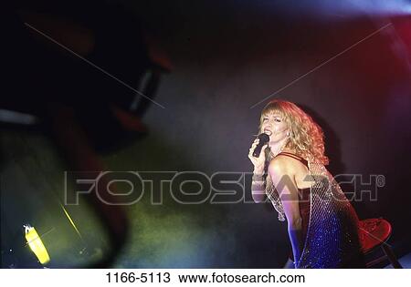 Stock Image - people, woman, music, arts, entertainment, blond, singing. Fotosearch