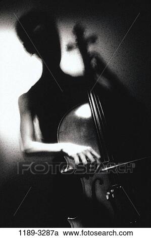Stock Image - people, woman, playing, music, silhouette, arts, entertainment. Fotosearch