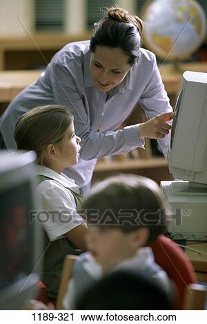 Stock Image - people, woman, teacher, school, computer, classroom, curious. Fotosearch