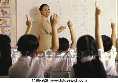 Stock Photo - people, woman, teacher, school, Middle-aged, arms, education. Fotosearch