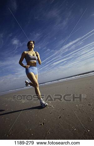 Stock Photo - sky, people, running, woman, healthy, beach, jogging. Fotosearch