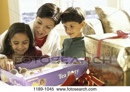 Stock Photography - smiling, morning, mother, Hispanic, open, Christmas. Fotosearch