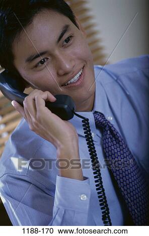 smiling, telephone, talking, Asian, listening, conversation View Large Photo Image Stock Image - smiling, telephone, talking, Asian, listening, conversation. Fotosearch