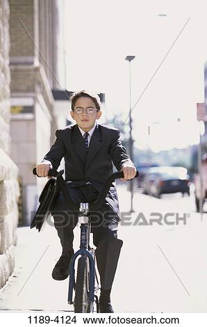 suit, riding, boy, business, outdoors, rider, bike View Large Photo Image Picture - suit, riding, boy, business, outdoors, rider, bike. Fotosearch