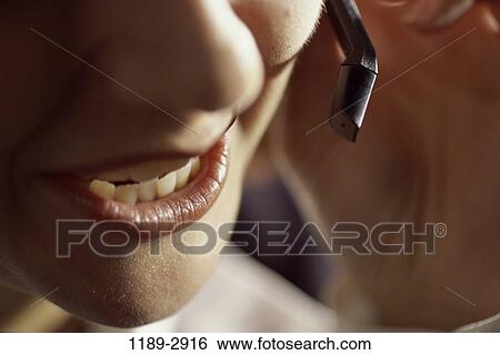 Stock Photograph - telephone, talking, phone, business, body parts, lips, microphone. Fotosearch