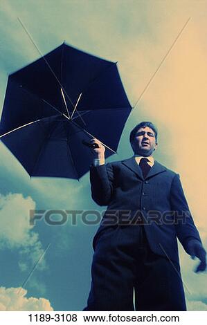 umbrella, holding, business, outdoors, Middle-aged, businessman View Large Photo Image Stock Photo - umbrella, holding, business, outdoors, Middle-aged, businessman. Fotosearch
