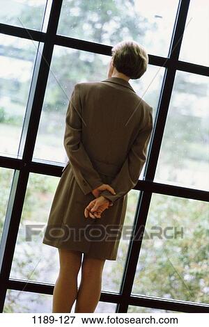 Stock Photo - window, back, business, contemplation, indoors, Caucasian, businesswoman. Fotosearch