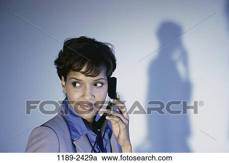 Stock Image - woman, smiling, telephone, shadow, listening, phone. Fotosearch