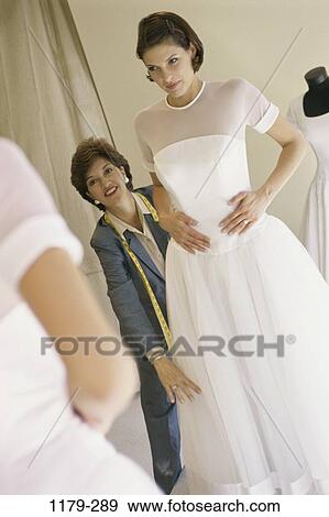 Stock Photo - women, people, industry, dress, business, store, fitting. Fotosearch