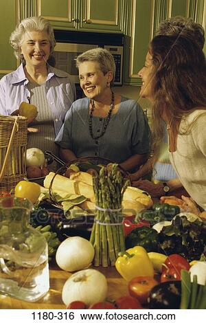 Stock Photograph - women, people, table, talking, cooking, onions, bread. Fotosearch