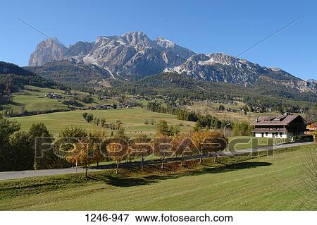 Stock Photo - Building at the roadside with a mountain in the background, Monte Cristallo, Cortina d'Ampezzo, Trentino, Italy. Fotosearch